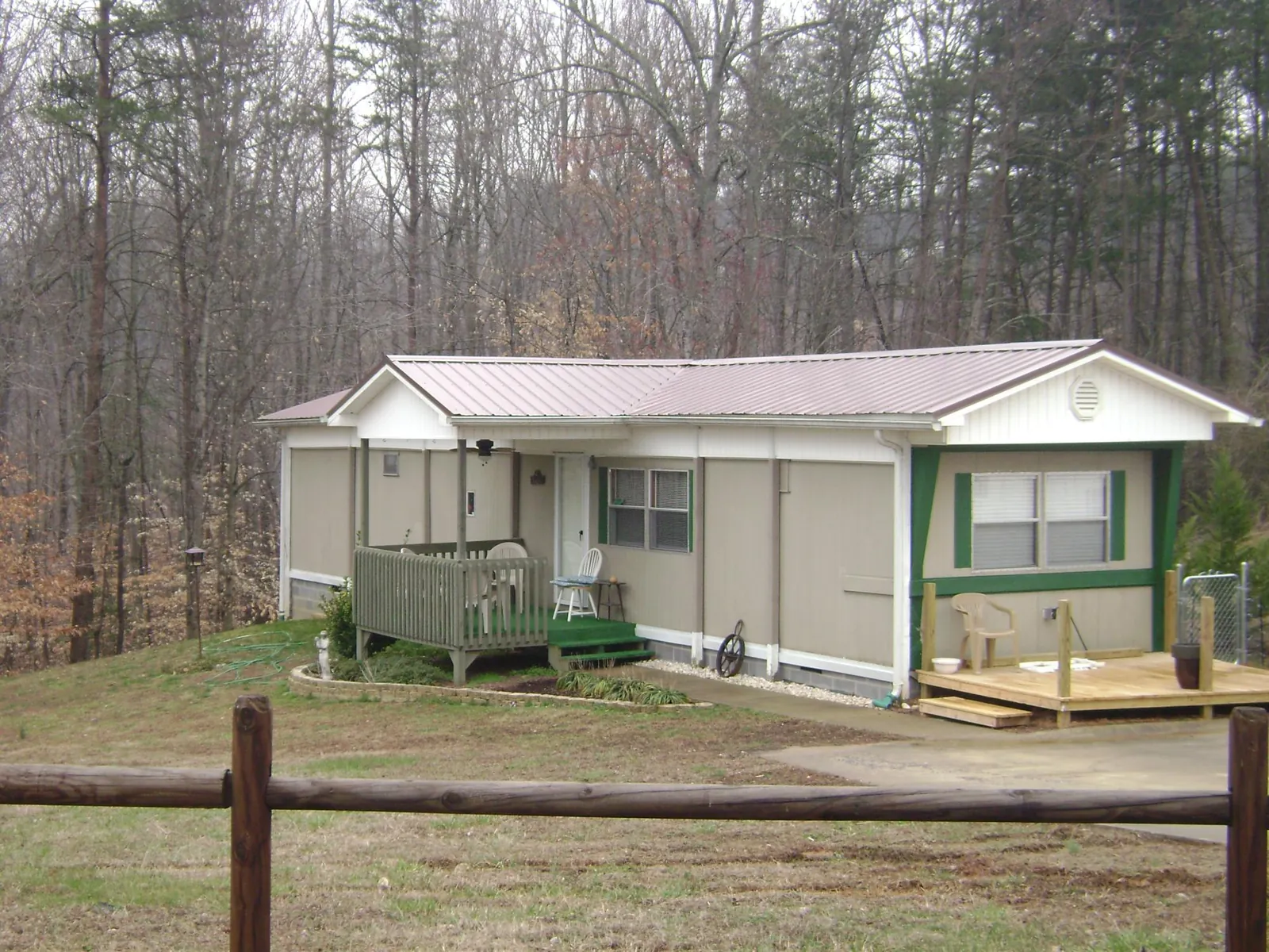 Mauve metal roof on a manufactured home with a new front deck in Dilworth